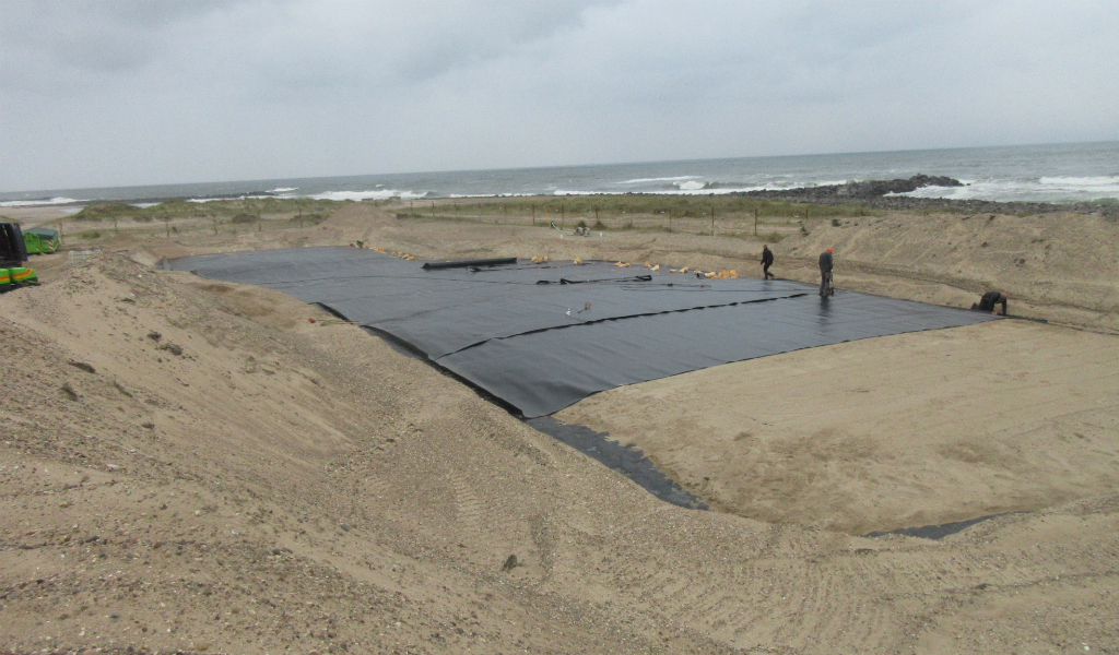 Arbejde i gang med at svejse membranen over den del af det indspunsede område, hvor den har været brudt. Selve forureningen ligger ca. 3,5-4 meter under terræn. Over membranen lægges yderligere et lag ren sand. Foto: Jacob Steffensen 